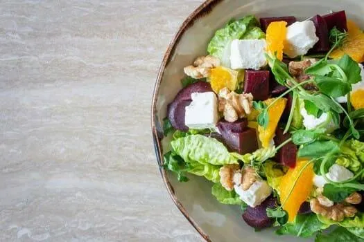 A photo of a salad that follows the food photography tips for styling: highlight the main dish, use fresh ingredients, & keep it simple.